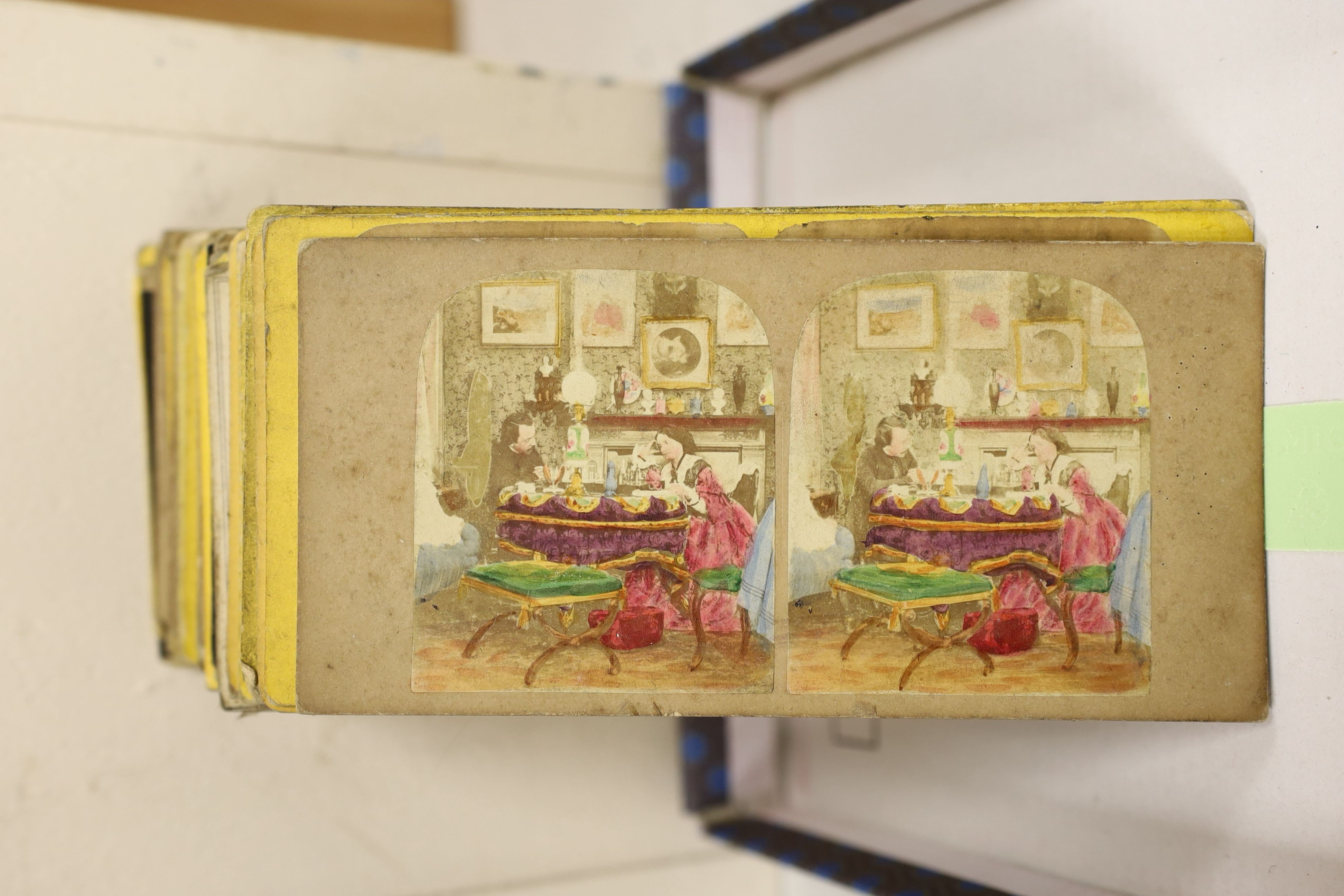 A Victorian walnut stereoscopic viewer and slides, a tinplate viewer, cigarette cards, Glamour Girls, etc.